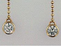 diamond (with yellow gold) hanging earrings closeup